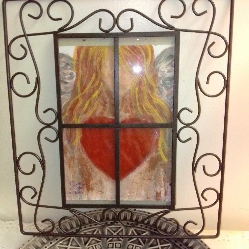 Hand painted angel painting. Black scroll frame.